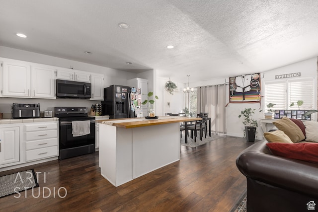 kitchen featuring dark hardwood / wood-style floors, wood counters, black appliances, white cabinets, and a textured ceiling