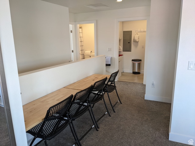 dining area featuring electric panel and dark carpet