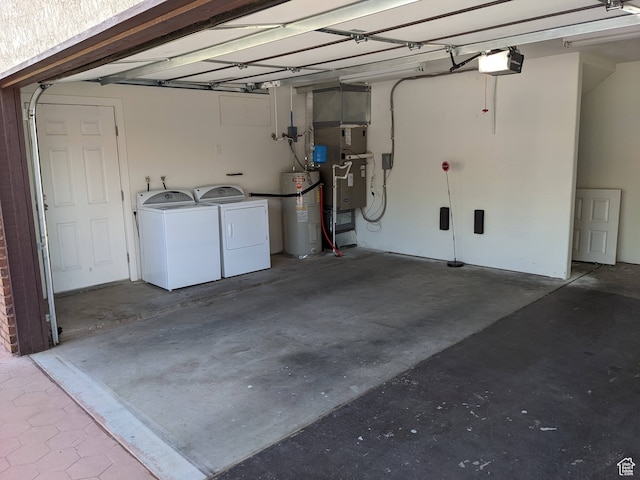 garage featuring a garage door opener, independent washer and dryer, and electric water heater