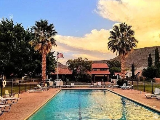 pool at dusk with a patio