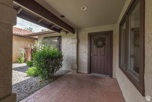 doorway to property with a patio area