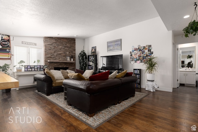 living room featuring a stone fireplace, a textured ceiling, vaulted ceiling, and dark hardwood / wood-style flooring