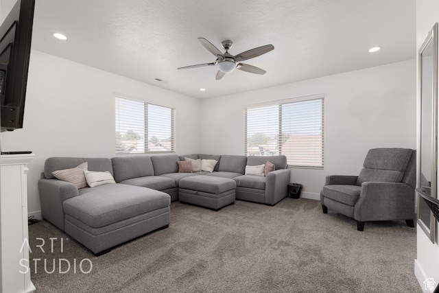 living room featuring carpet, plenty of natural light, and ceiling fan