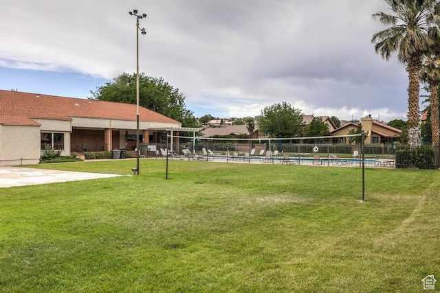 view of home's community featuring a yard and a swimming pool
