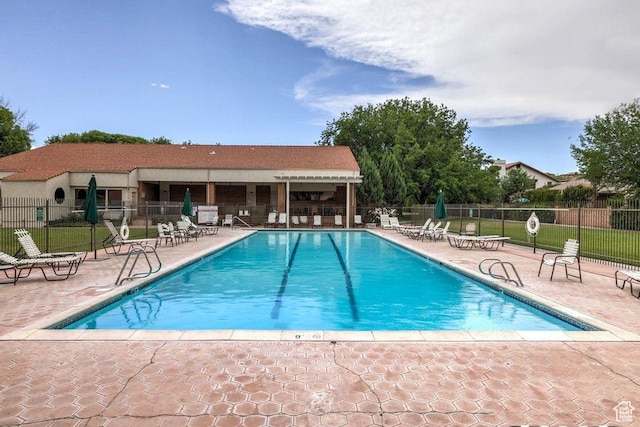 view of swimming pool featuring a patio area