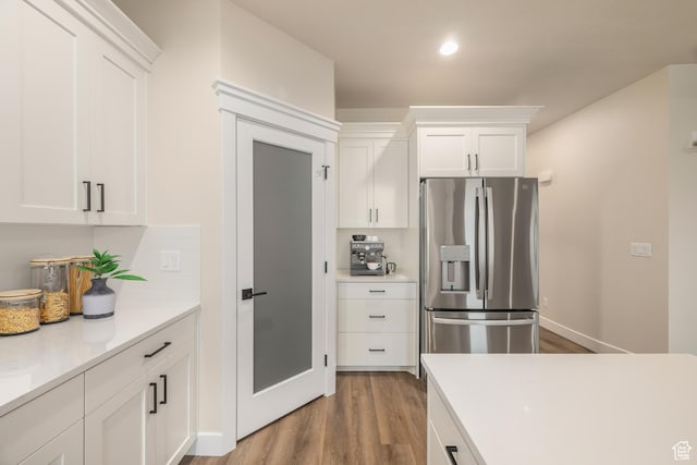 447 S 580 W, Providence, UT 84332 - kitchen featuring stainless steel fridge with ice dispenser, wood finished floors, light countertops, white cabinetry, and recessed lighting
