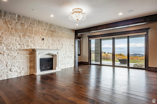 1254 N Explorer Peak Cir, Heber City, UT 84032 - unfurnished living room featuring wood finished floors, recessed lighting, a glass covered fireplace, a notable chandelier, and a mountain view
