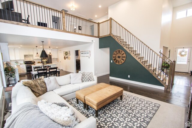 520 N 900 E, Hyde Park, UT 84318 - living room with a towering ceiling, stairs, dark wood finished floors, recessed lighting, and baseboards