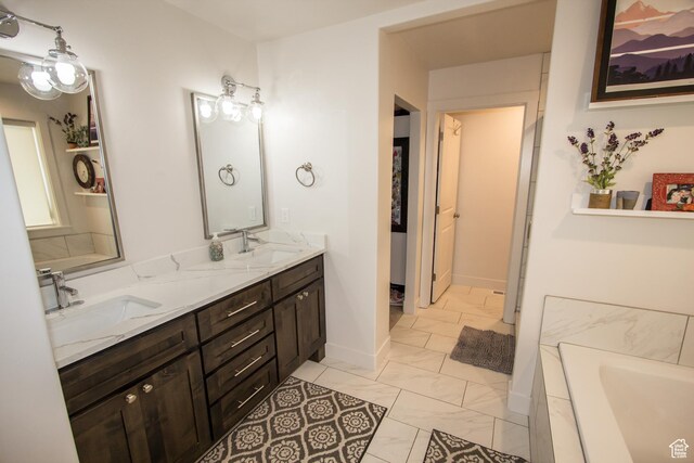 520 N 900 E, Hyde Park, UT 84318 - bathroom with double vanity, marble look tile flooring, a bathtub, and baseboards