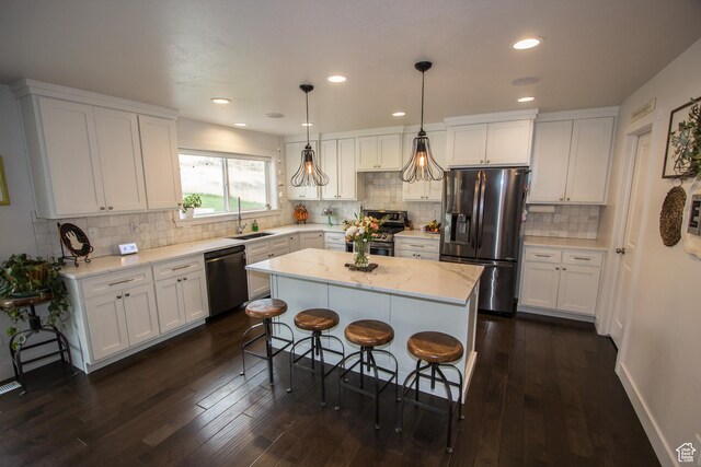 520 N 900 E, Hyde Park, UT 84318 - kitchen with stainless steel appliances, a sink, white cabinetry, decorative backsplash, and recessed lighting