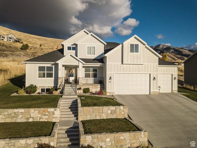 520 N 900 E, Hyde Park, UT 84318 - view of front of property with board and batten siding, driveway, an attached garage, and a front yard