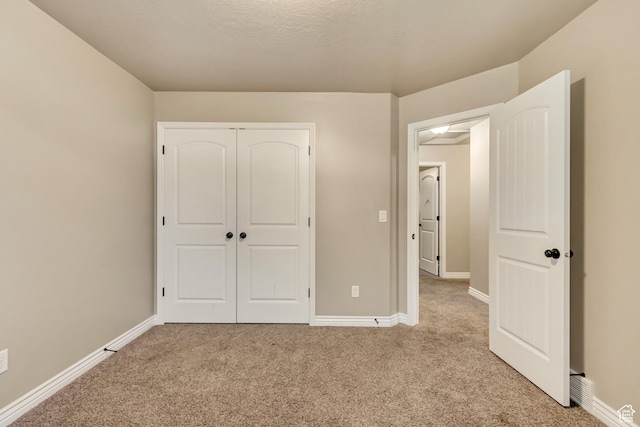 995 W 2650 S, Perry, UT 84302 - unfurnished bedroom with light colored carpet, baseboards, and a closet
