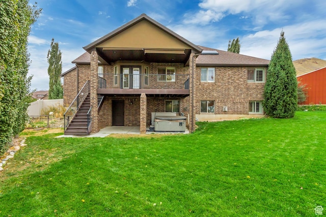 995 W 2650 S, Perry, UT 84302 - rear view of property featuring a hot tub, brick siding, a patio area, and stairs