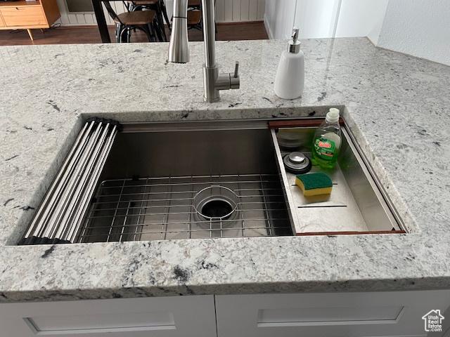 385 S Vasels Rd Unit 21, Brian Head, UT 84719 - kitchen view of a sink, light stone countertops, and white cabinetry