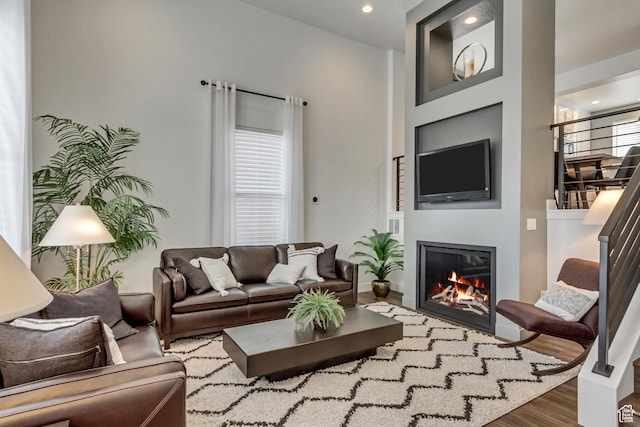 11211 S Clear Blue Dr, South Jordan, UT 84009 - living room featuring wood finished floors, a glass covered fireplace, stairway, recessed lighting, and baseboards