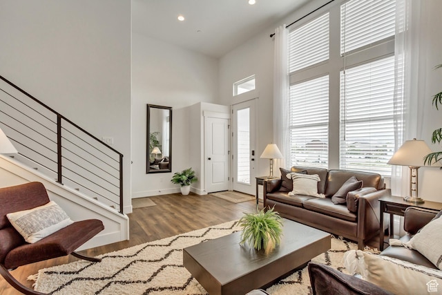 11211 S Clear Blue Dr, South Jordan, UT 84009 - living area featuring a high ceiling, plenty of natural light, stairway, wood finished floors, and baseboards