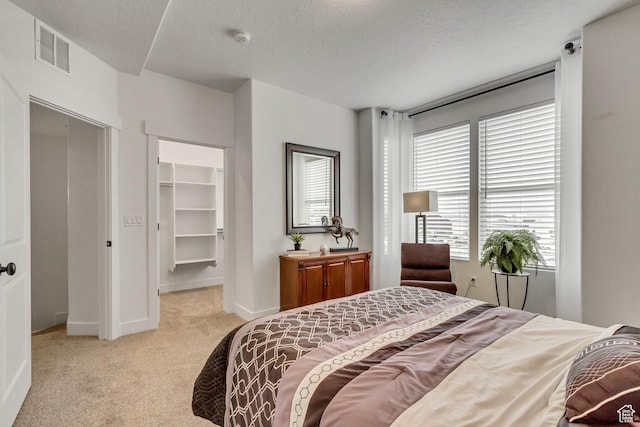 11211 S Clear Blue Dr, South Jordan, UT 84009 - carpeted bedroom featuring a spacious closet, baseboards, a textured ceiling, and a closet