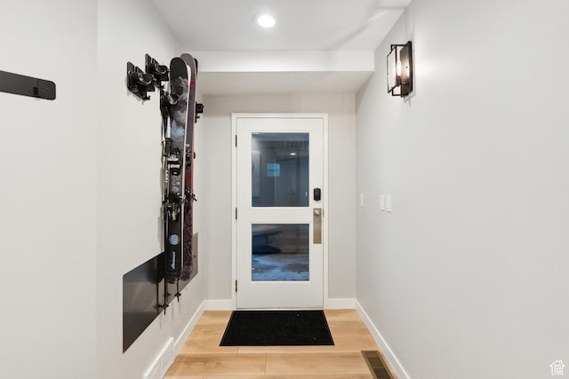 doorway featuring light wood-type flooring, recessed lighting, baseboards, and visible vents