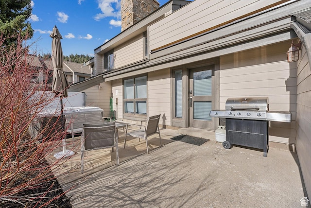 view of patio with a hot tub and grilling area