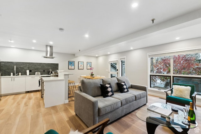 living area with indoor wet bar, recessed lighting, and light wood-style floors