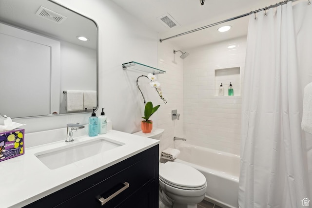 bathroom featuring vanity, shower / bath combo with shower curtain, toilet, and visible vents