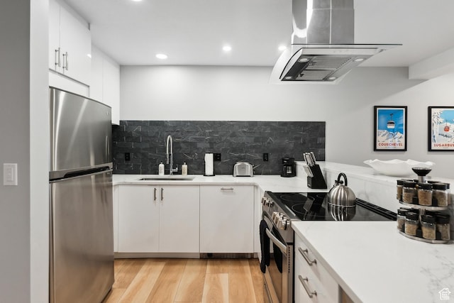 kitchen with a sink, decorative backsplash, stainless steel appliances, and island exhaust hood