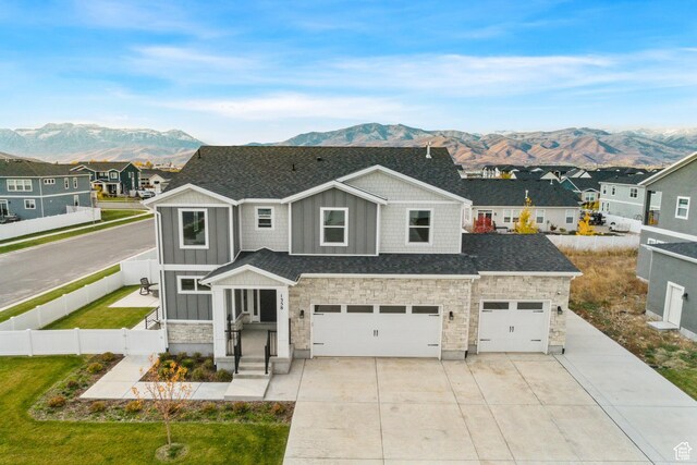 1358 S 1140 E, Heber City, UT 84032 - view of front of home featuring a mountain view, board and batten siding, driveway, stone siding, and a garage