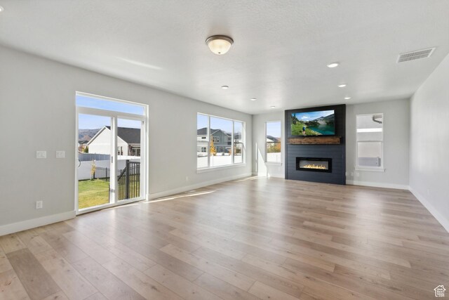 1358 S 1140 E, Heber City, UT 84032 - unfurnished living room with plenty of natural light, light wood-style flooring, baseboards, a fireplace, and recessed lighting