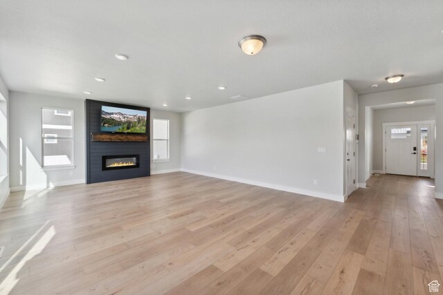 1358 S 1140 E, Heber City, UT 84032 - unfurnished living room with a large fireplace, light wood-type flooring, baseboards, and recessed lighting