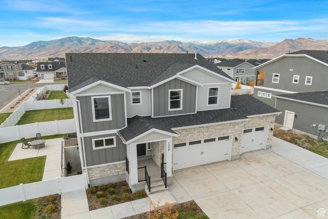 1358 S 1140 E, Heber City, UT 84032 - view of front of property featuring board and batten siding, stone siding, a mountain view, and a fenced backyard