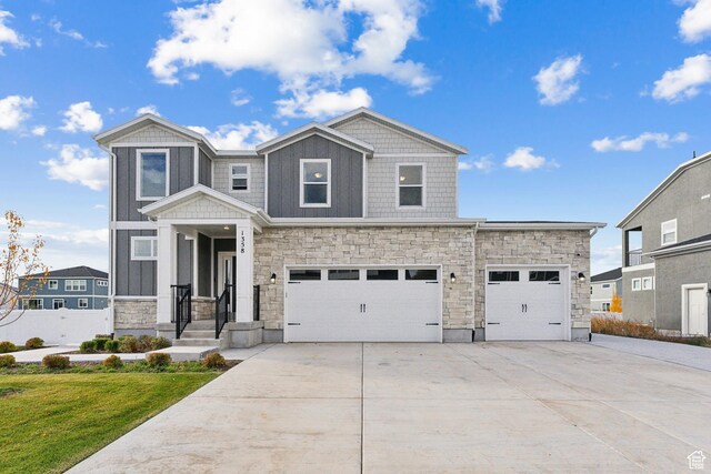 1358 S 1140 E, Heber City, UT 84032 - view of front of house featuring stone siding, driveway, a garage, and a front lawn