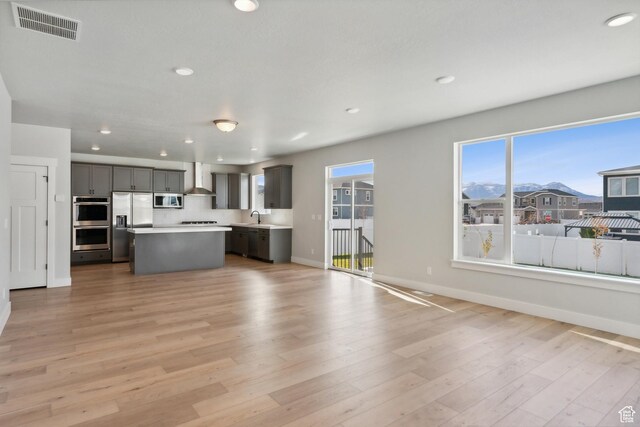 1358 S 1140 E, Heber City, UT 84032 - kitchen featuring stainless steel appliances, open floor plan, gray cabinets, wall chimney range hood, and recessed lighting