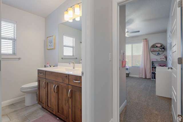 bathroom featuring ceiling fan, vanity, and toilet