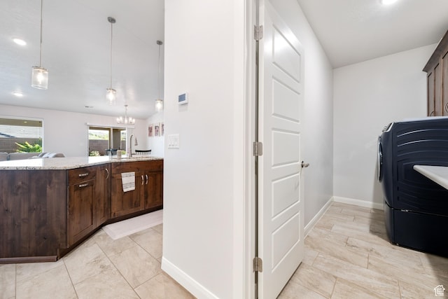2084 E Sunshine Trl, St George, UT 84790 - laundry area with a sink, baseboards, a chandelier, light tile patterned flooring, and recessed lighting