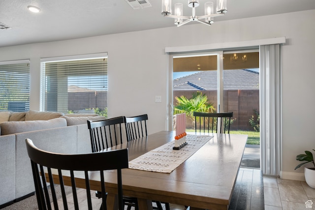 dining area featuring a notable chandelier and light hardwood / wood-style flooring