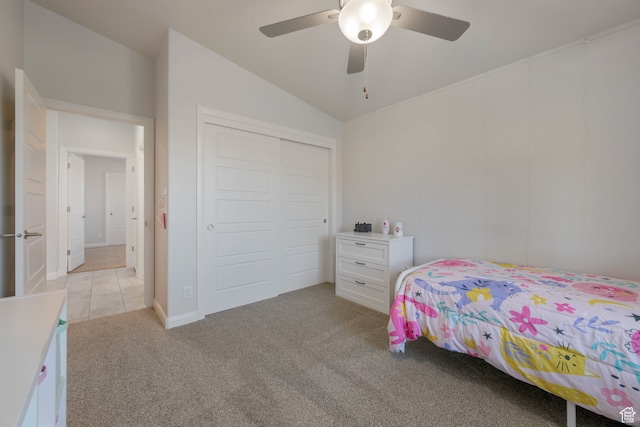 carpeted bedroom featuring lofted ceiling, ceiling fan, and a closet