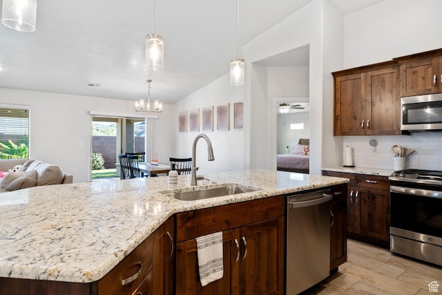 2084 E Sunshine Trl, St George, UT 84790 - kitchen with appliances with stainless steel finishes, a sink, backsplash, open floor plan, and lofted ceiling