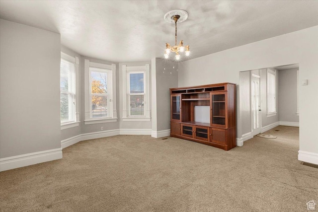 114 E Main St, Moroni, UT 84646 - unfurnished living room featuring a chandelier and carpet flooring
