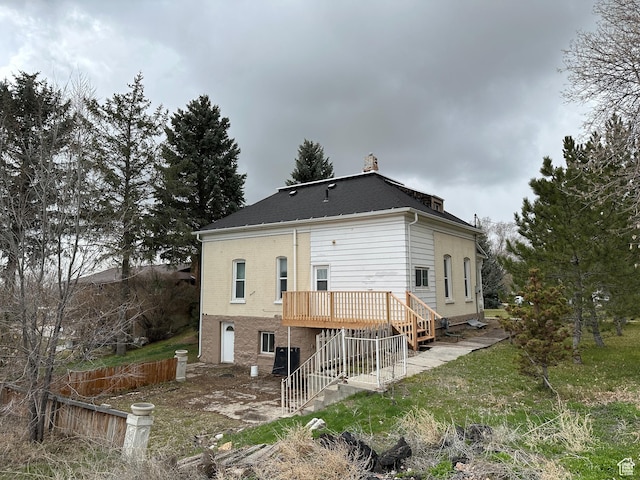 114 E Main St, Moroni, UT 84646 - rear view of house with stairway, a wooden deck, brick siding, and roof with shingles