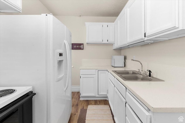 114 E Main St, Moroni, UT 84646 - kitchen featuring white refrigerator with ice dispenser, wood finished floors, white cabinetry, and light countertops
