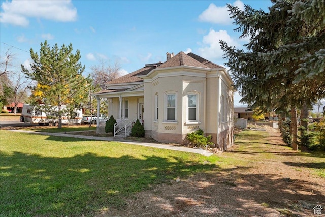 114 E Main St, Moroni, UT 84646 - view of front of home with a front lawn, covered porch, a chimney, and a shingled roof
