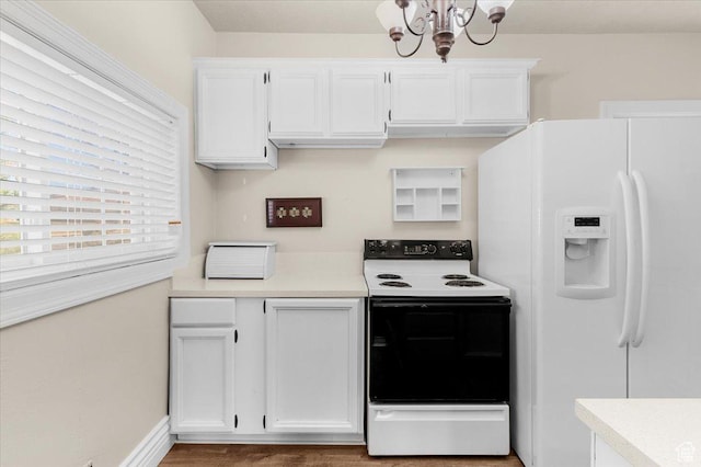 114 E Main St, Moroni, UT 84646 - kitchen with white appliances, a chandelier, white cabinetry, and light countertops