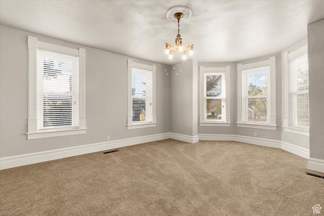114 E Main St, Moroni, UT 84646 - carpeted spare room with a chandelier and baseboards