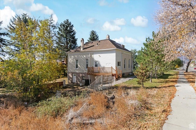 114 E Main St, Moroni, UT 84646 - view of property exterior with stairs, a deck, and a chimney
