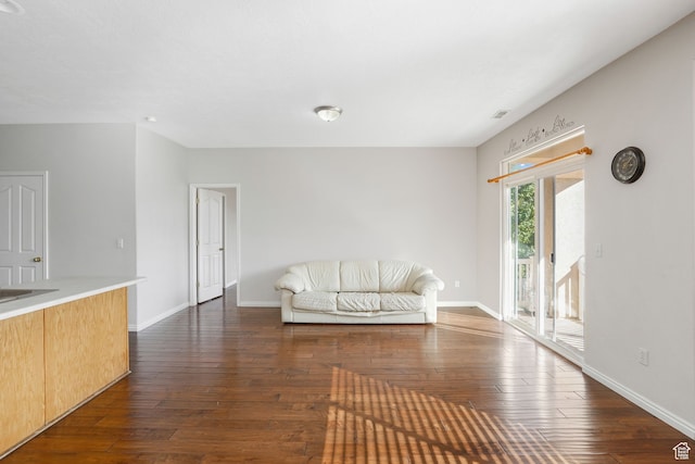 6882 W Bamburgh Way W, West Valley City, UT 84128 - unfurnished living room with dark wood-type flooring