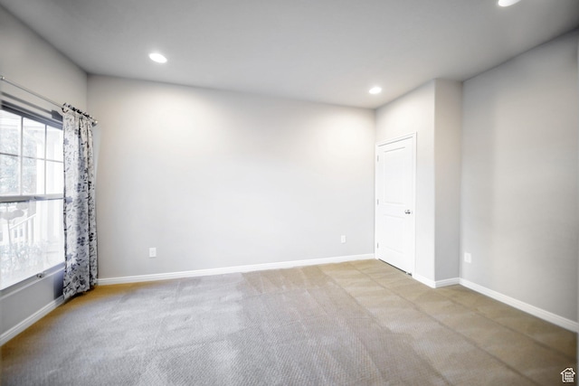 carpeted spare room with baseboards and recessed lighting