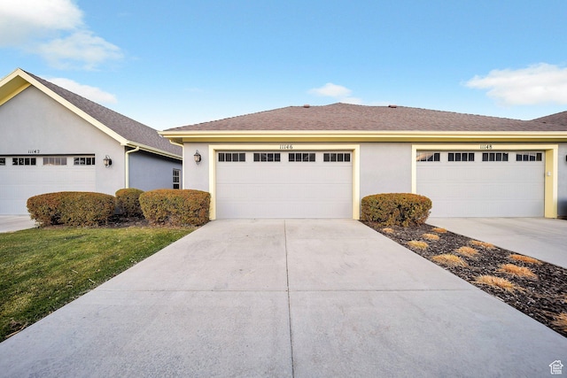 ranch-style home with driveway, stucco siding, and a front lawn