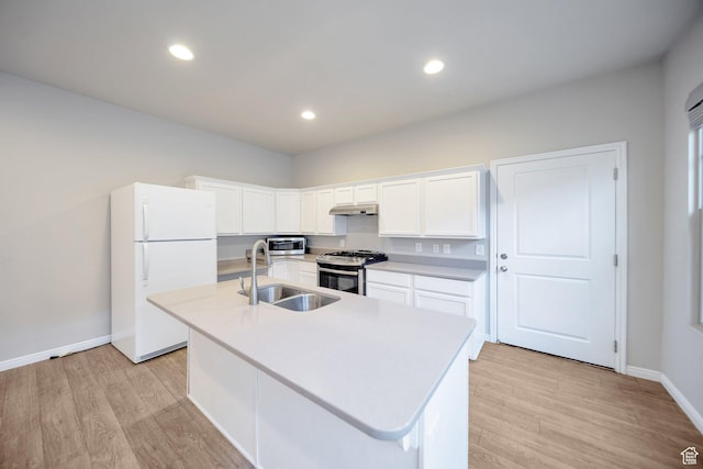 kitchen with light countertops, stainless steel appliances, light wood-style flooring, and a sink