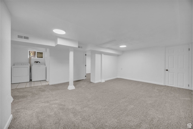 basement with independent washer and dryer and light colored carpet