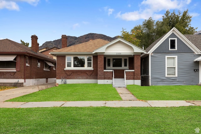 bungalow-style home with a front lawn